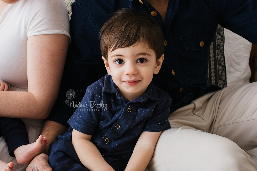 toddler boy with family in blue shirt