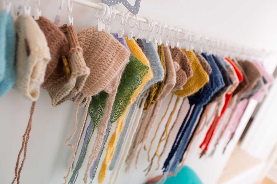 a large collection of hand made and varous colours wool bonnets