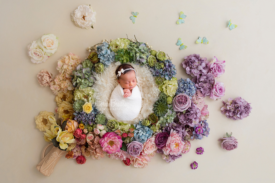 floral newborn baby girl in flower basket