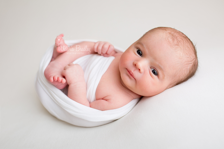 newborn baby boy in a white wrap