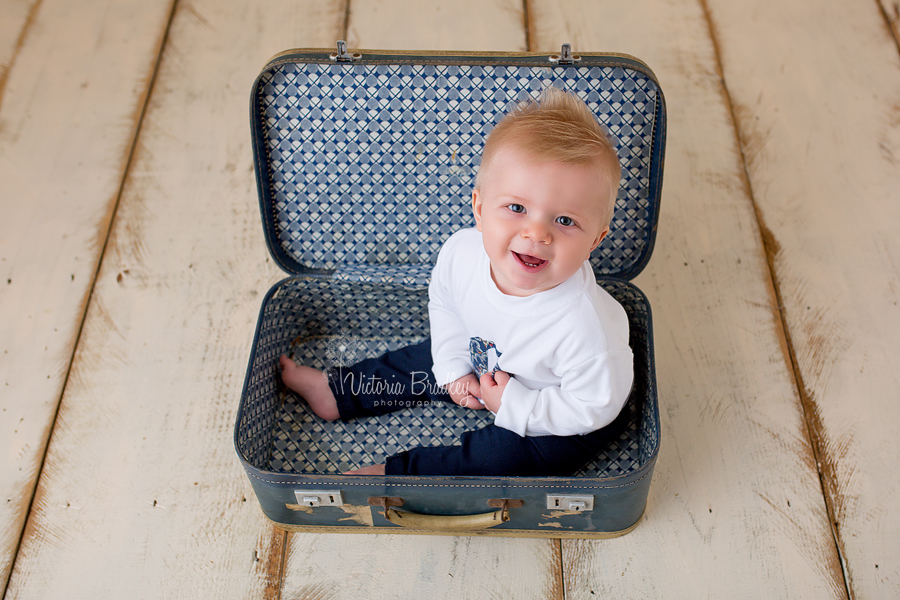 sitter baby boy in vintage blue suitcase