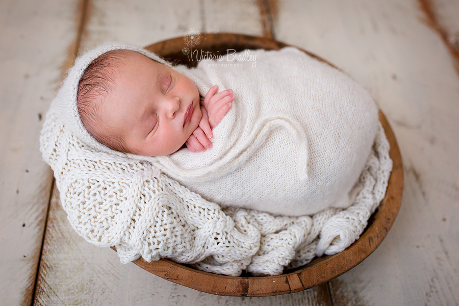 wrapped newborn boy in cream knitted wrap