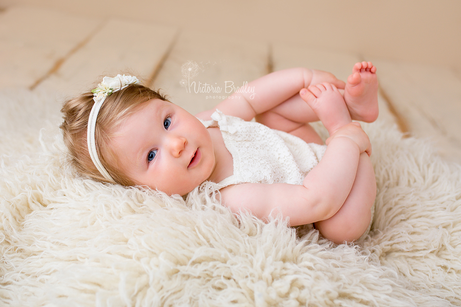 baby girl in cream romper during her nottinghamshire baby photography session