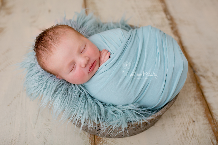 baby boy newborn photography session with duck egg wrap