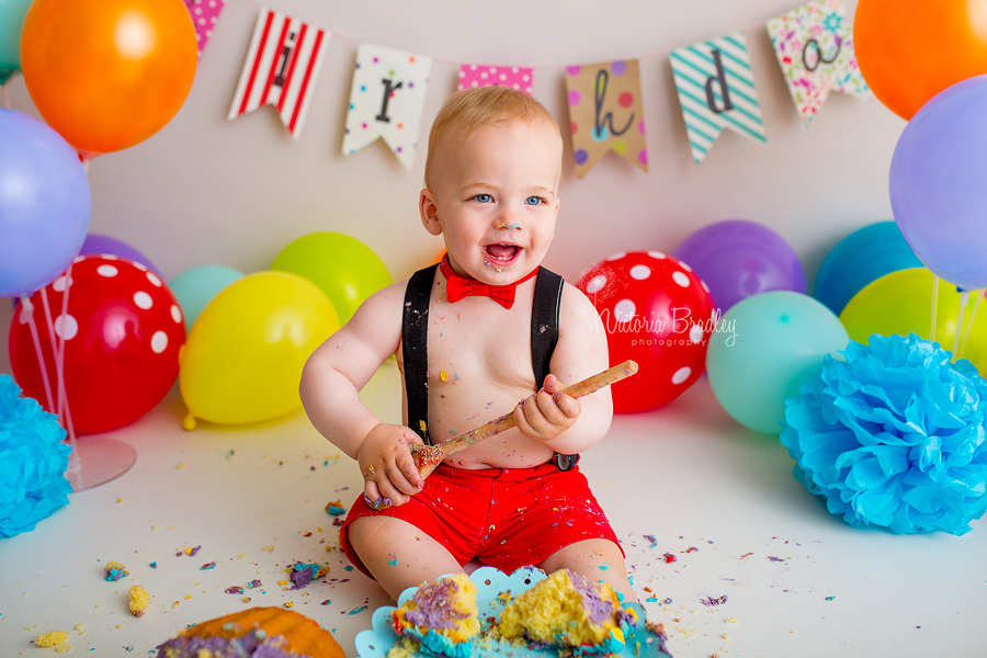 baby boy rainbow cake smash with wooden spoon