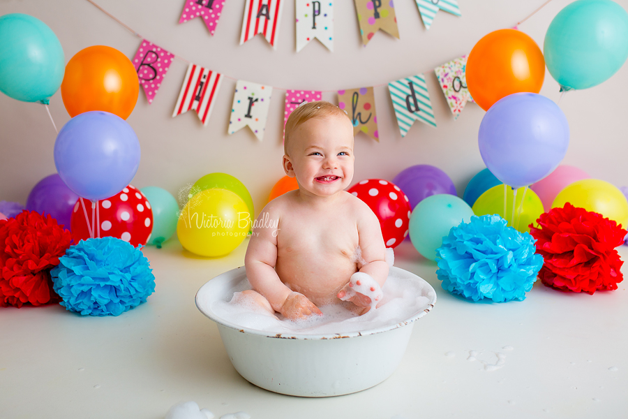 rainbow cake smash with vintage white bath tub and bubbles