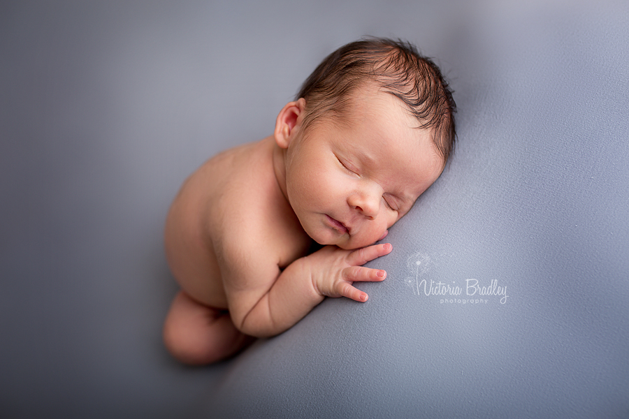 baby boy newborn on grey backdrop