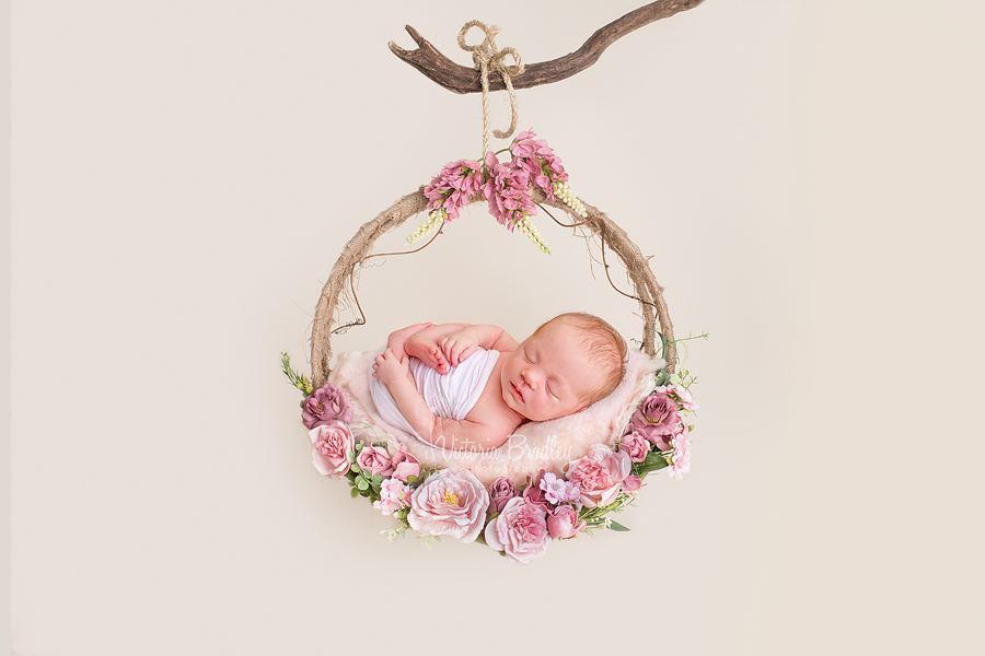 wrapped newborn photography  on swing