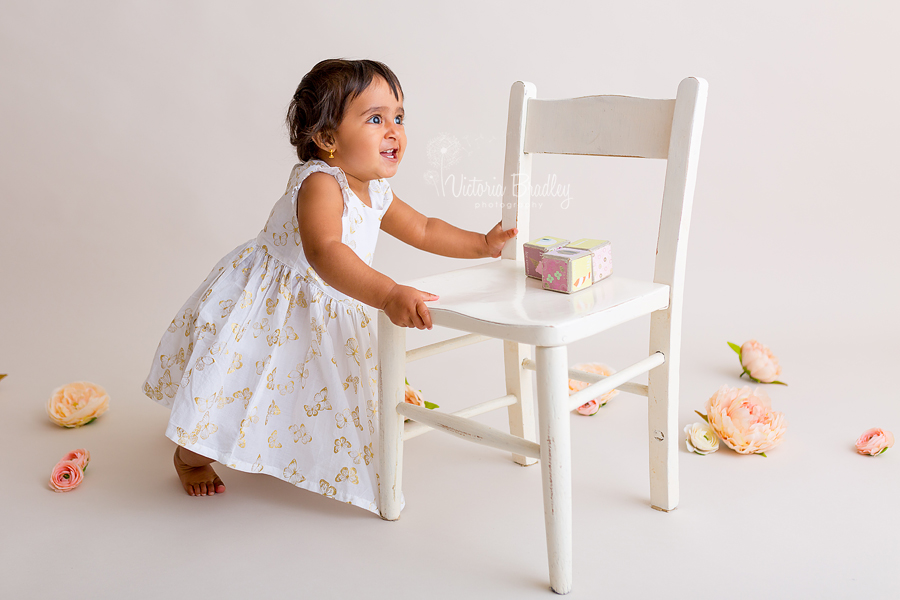 cake smash photography baby girl with white chair