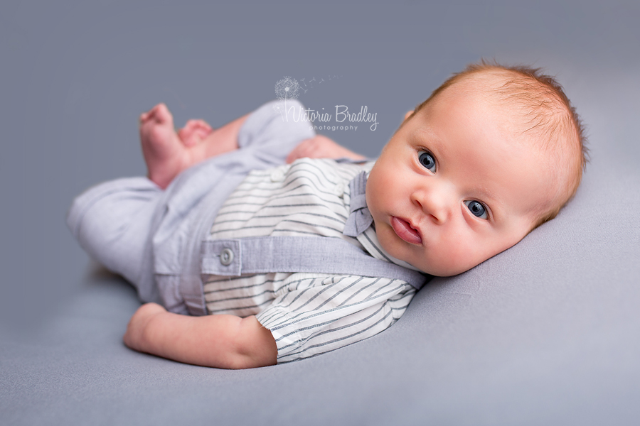 newborn baby on grey backdrop