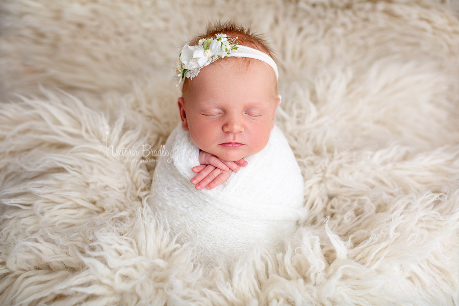 potato sack pose with newborn girl