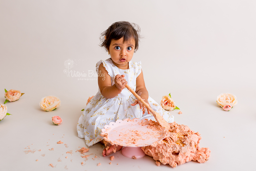 cake smash photography baby girl with wooden spoon