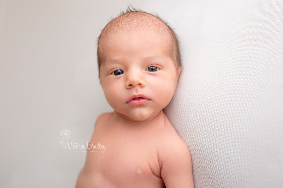 newborn photography session awake baby on cram blanket