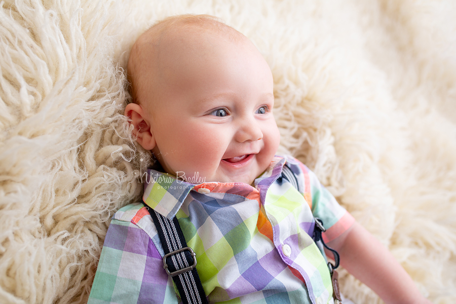 baby photography session on cream flokati rug