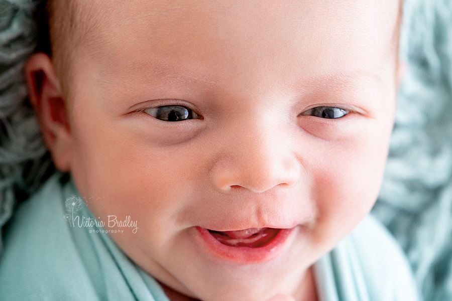 close up macro shot of baby newborn smiling