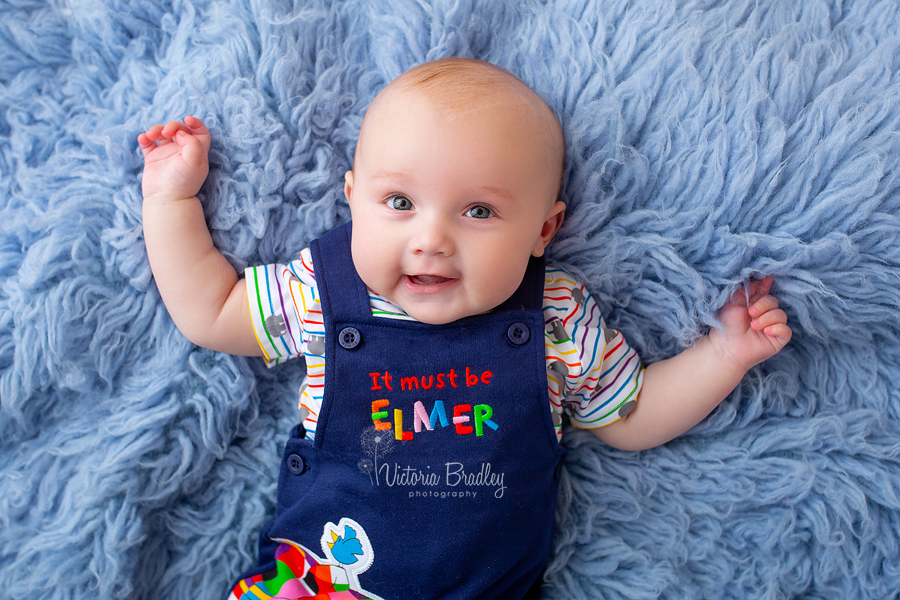 baby photography session on blue flokati rug