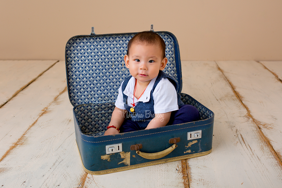 baby boy in blue suitcase