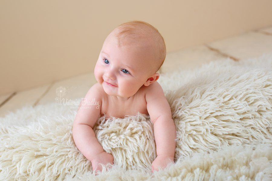 baby photography session on cream flokati rug