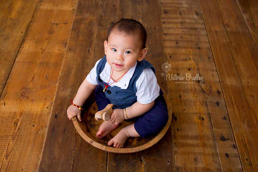 baby boy in wooden bowl