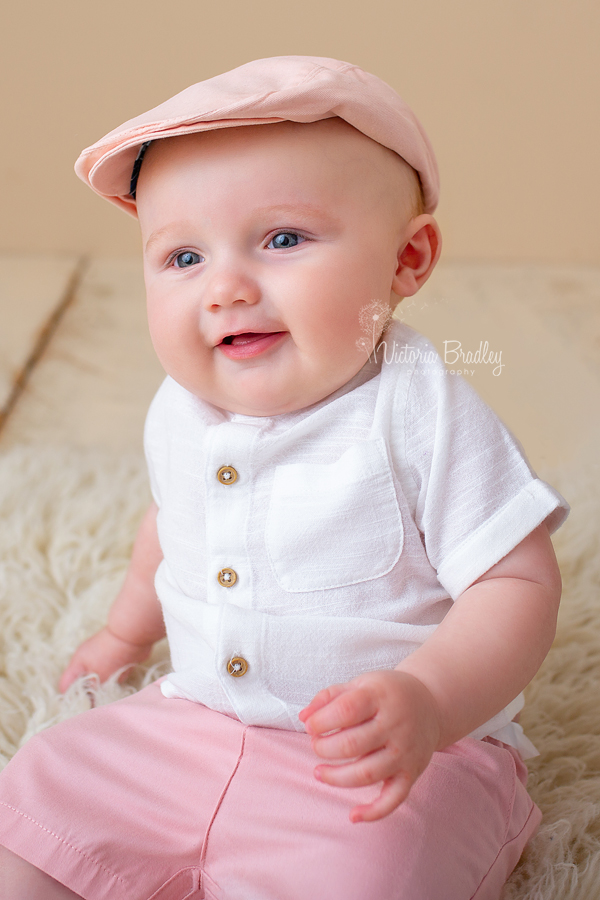 baby photography session with flat cap