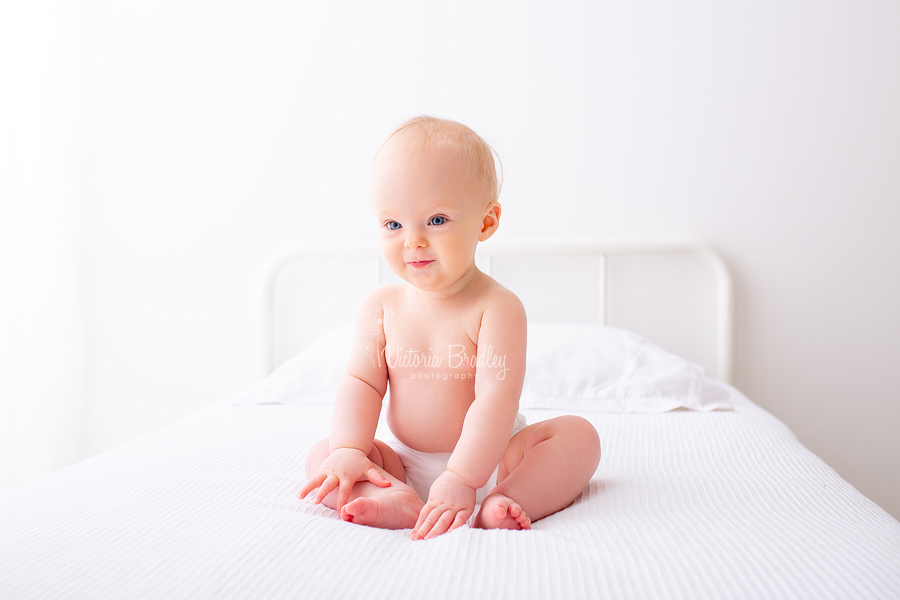 baby girl on white bed