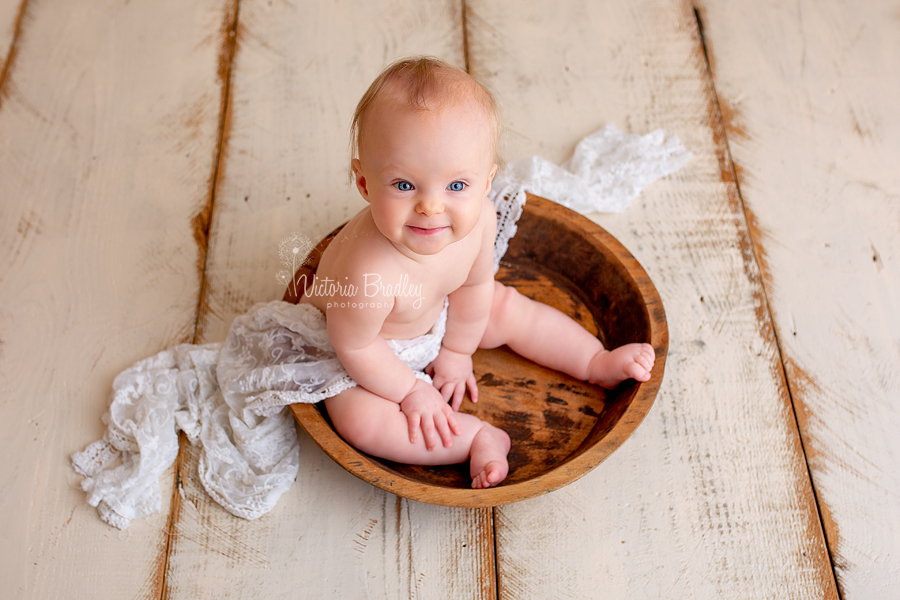 baby girl in wooden bowl
