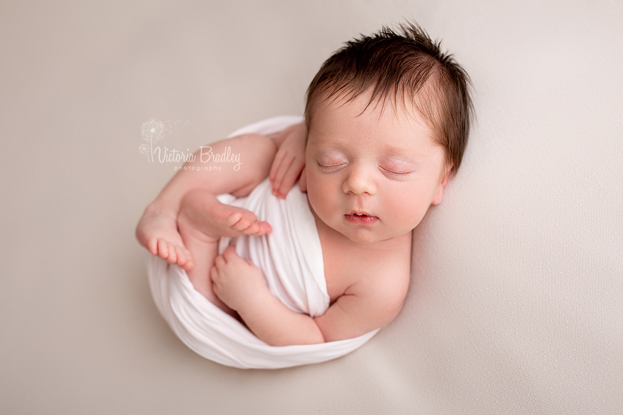 baby girl on cream blanket