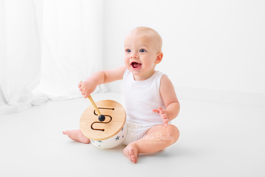 baby in white room with white drum