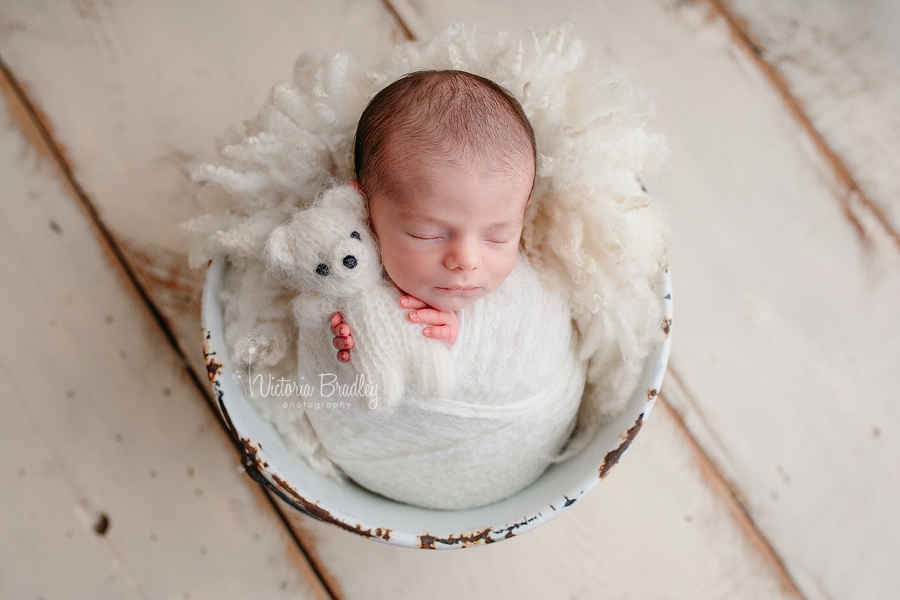 newborn baby photography in metal bucket