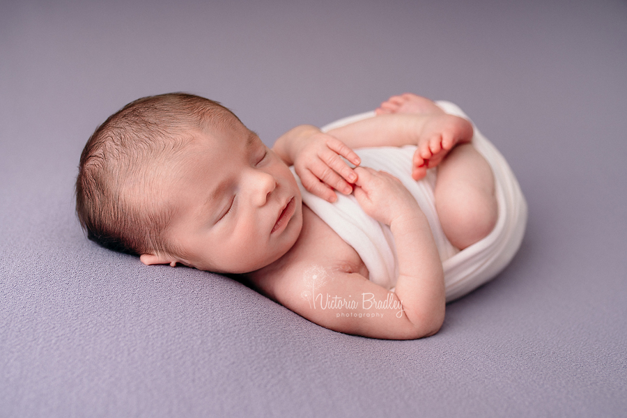 newborn baby photography on lilac backdrop