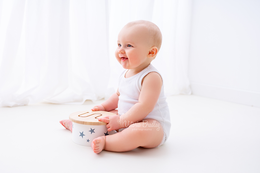 baby white studio photography with drum