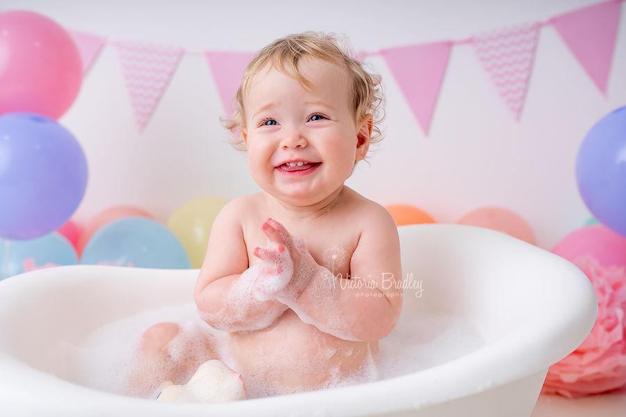 pastel rainbow cake smash photography smiley baby