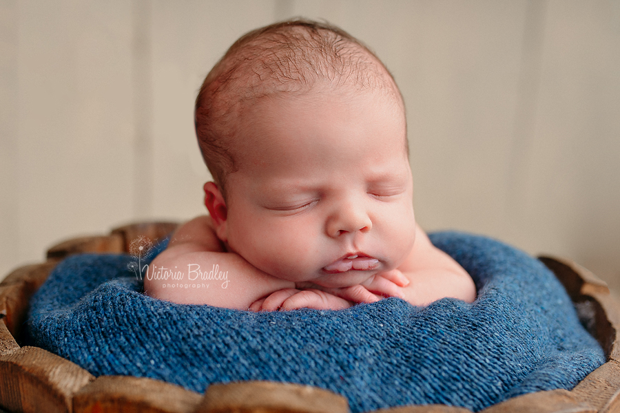 wrapped newborn baby photography, baby in wooden bucket with blue blanket