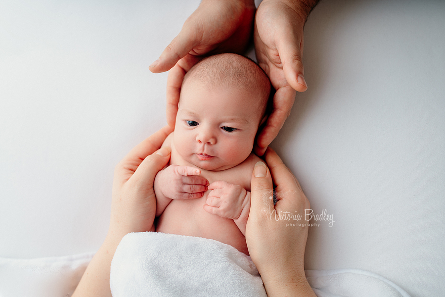 newborn in mummy and daddys hands