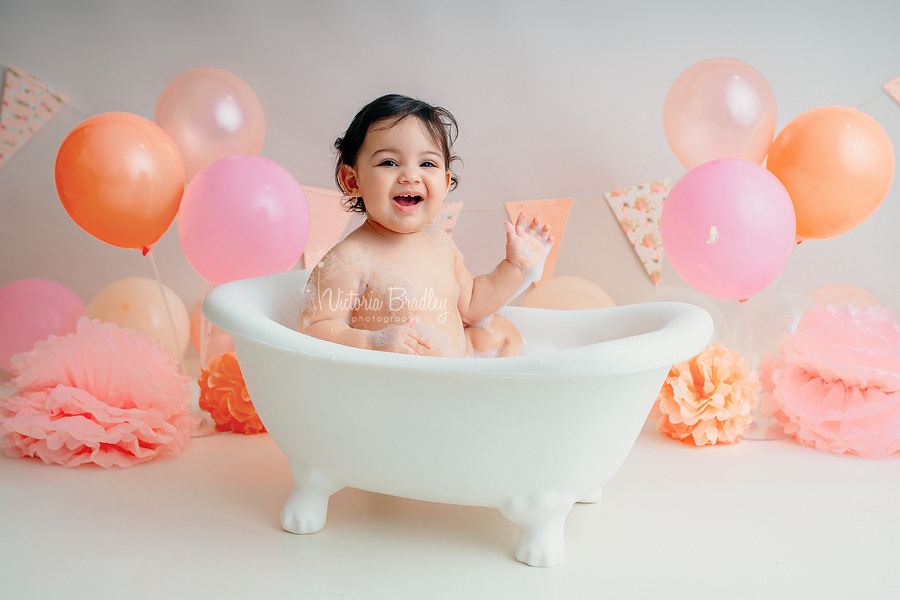 baby girl in white bath tub photography