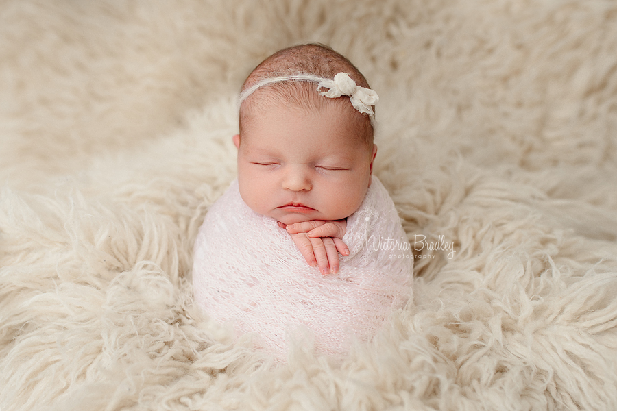 potato sack pose newborn baby girl