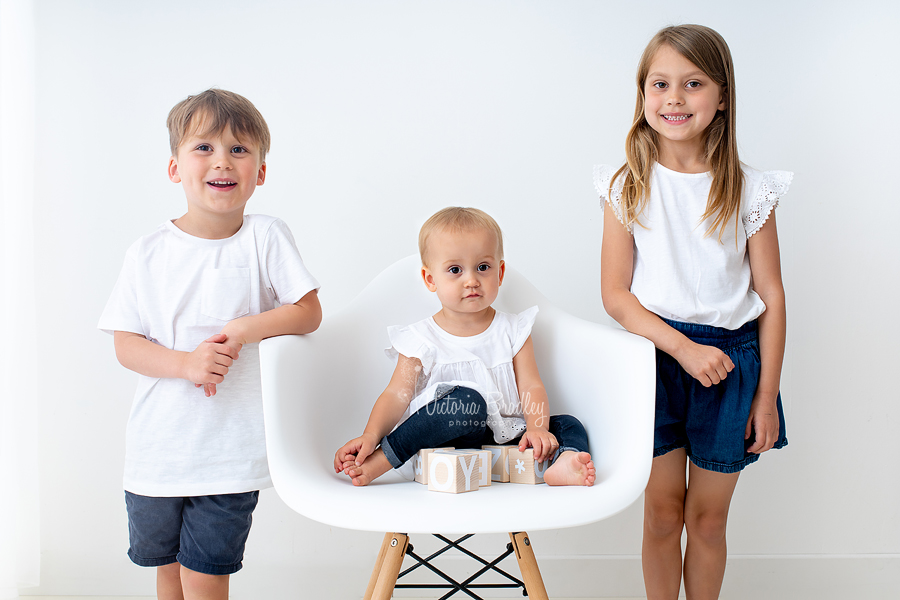 toddler and siblings on Eiffel chair