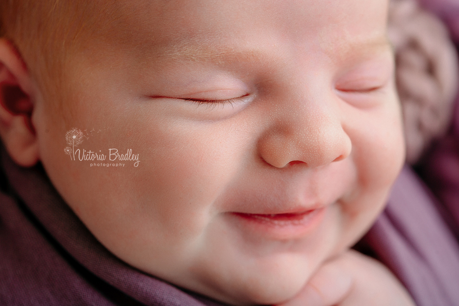 close up of newborn smiling