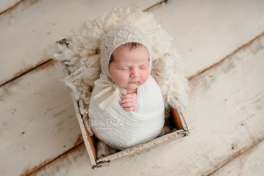 wrapped newborn in neutral tones