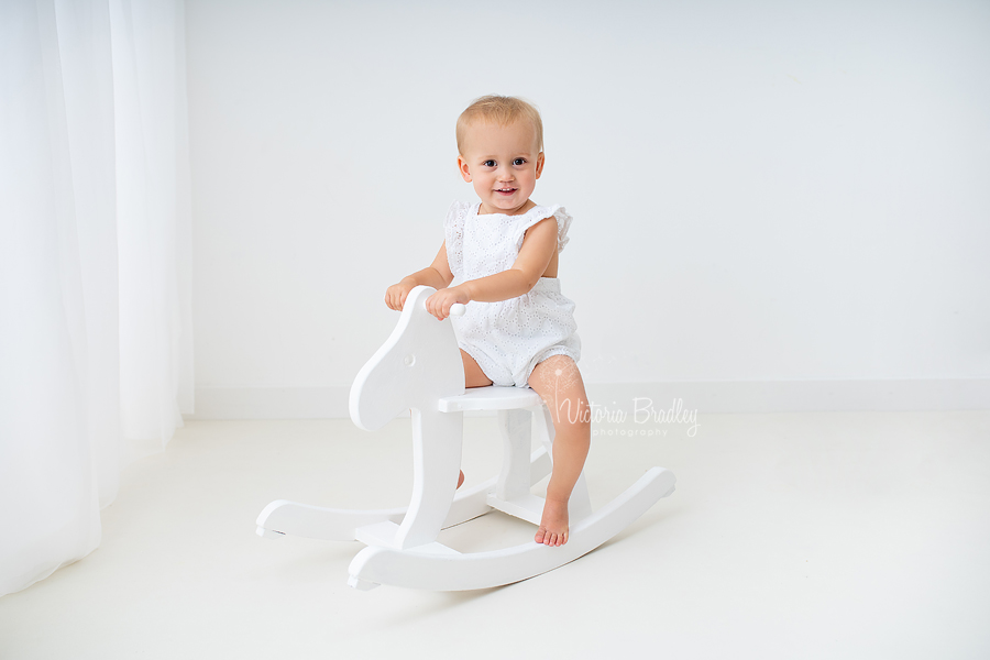 toddler on white rocking horse