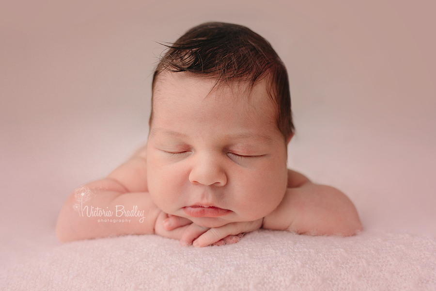 chin on hands pose newborn photography