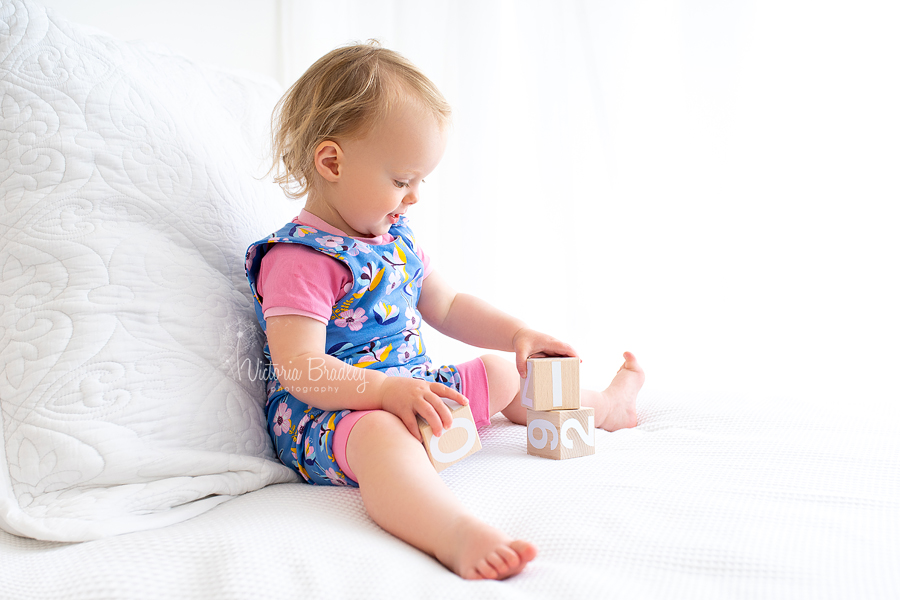 toddler photography on white bed