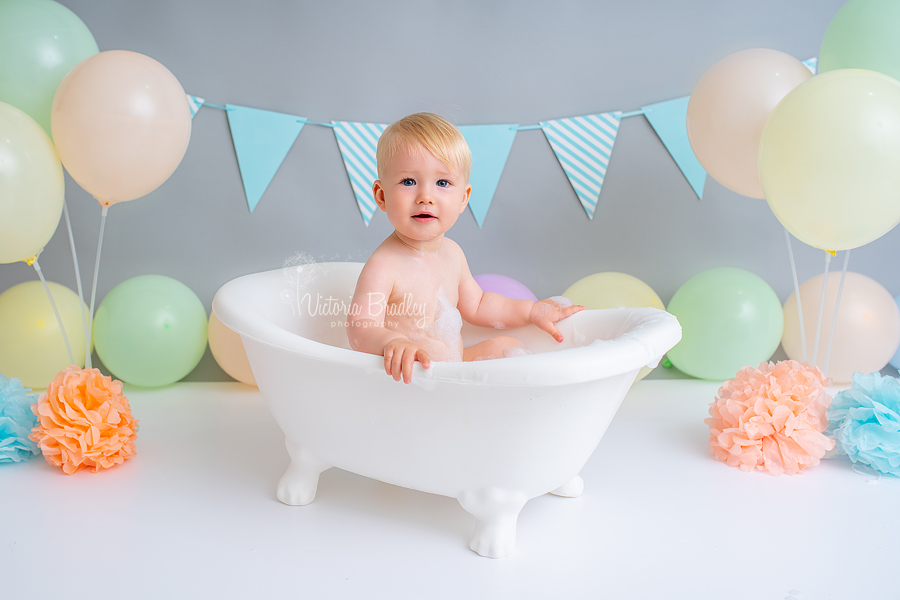 baby boy cake smash rainbow in white bath tub