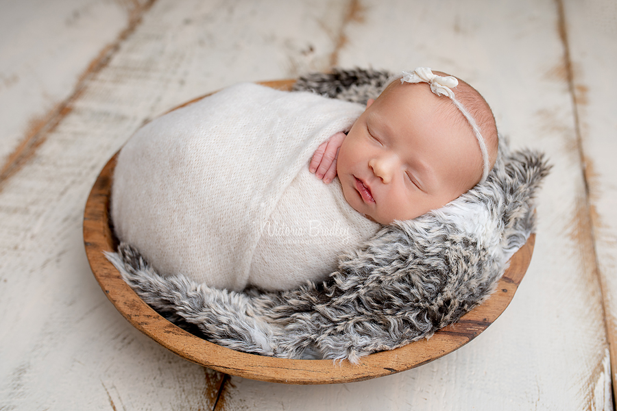 wrapped newborn in wooden bowl photography