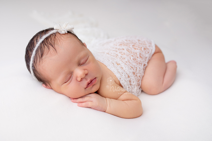 sleepy newborn on tummy photography