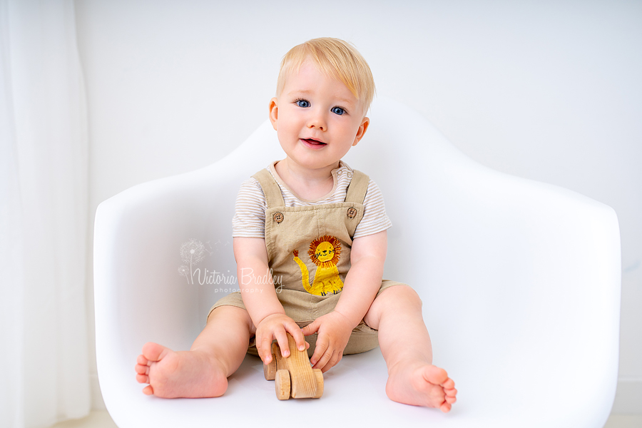 1 year old sat on white chair