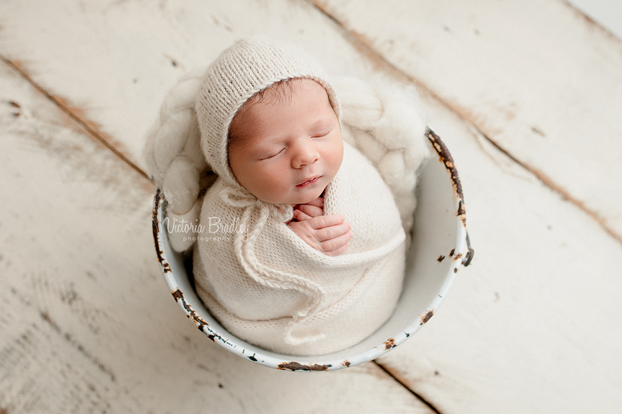 wrapped newborn photography nottingham, cream knitted wrap in white bucket