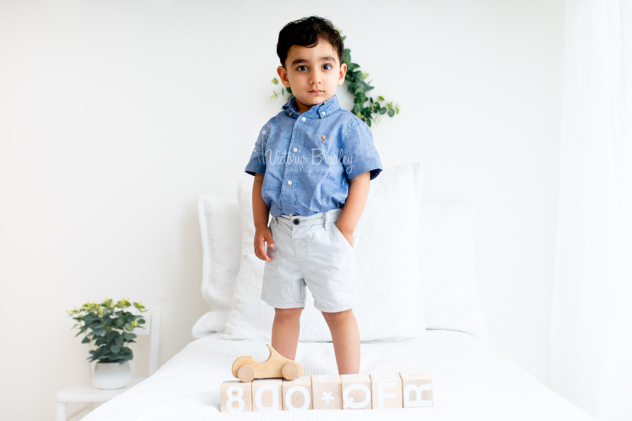 white room bed toddler photography