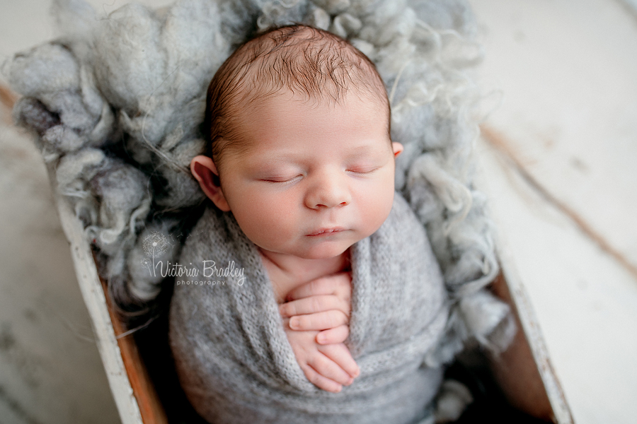swaddled newborn photography in pale grey wrap