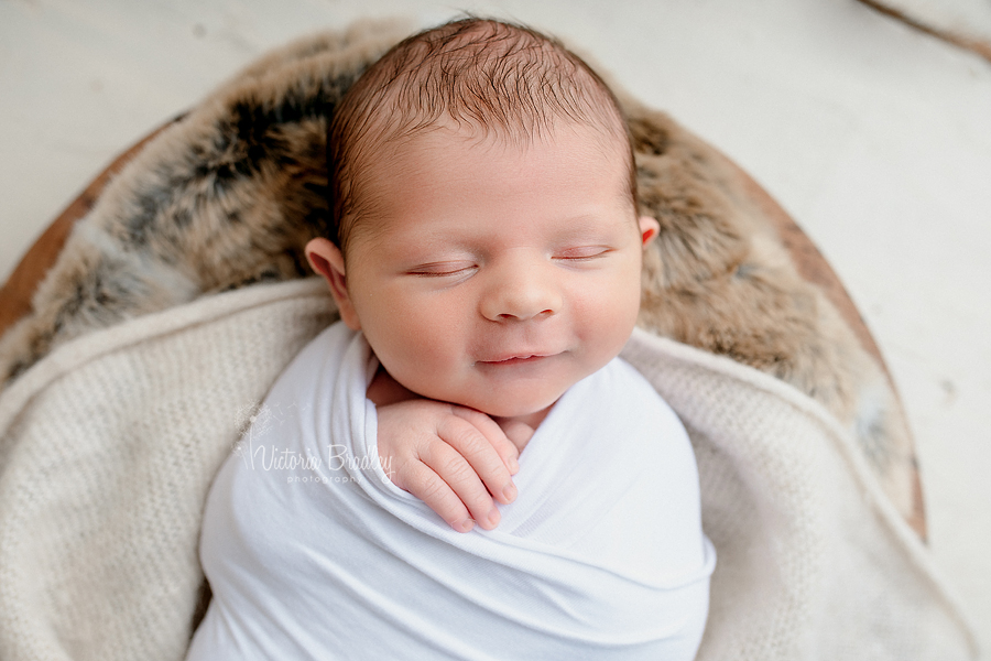 smiling newborn during photography session 